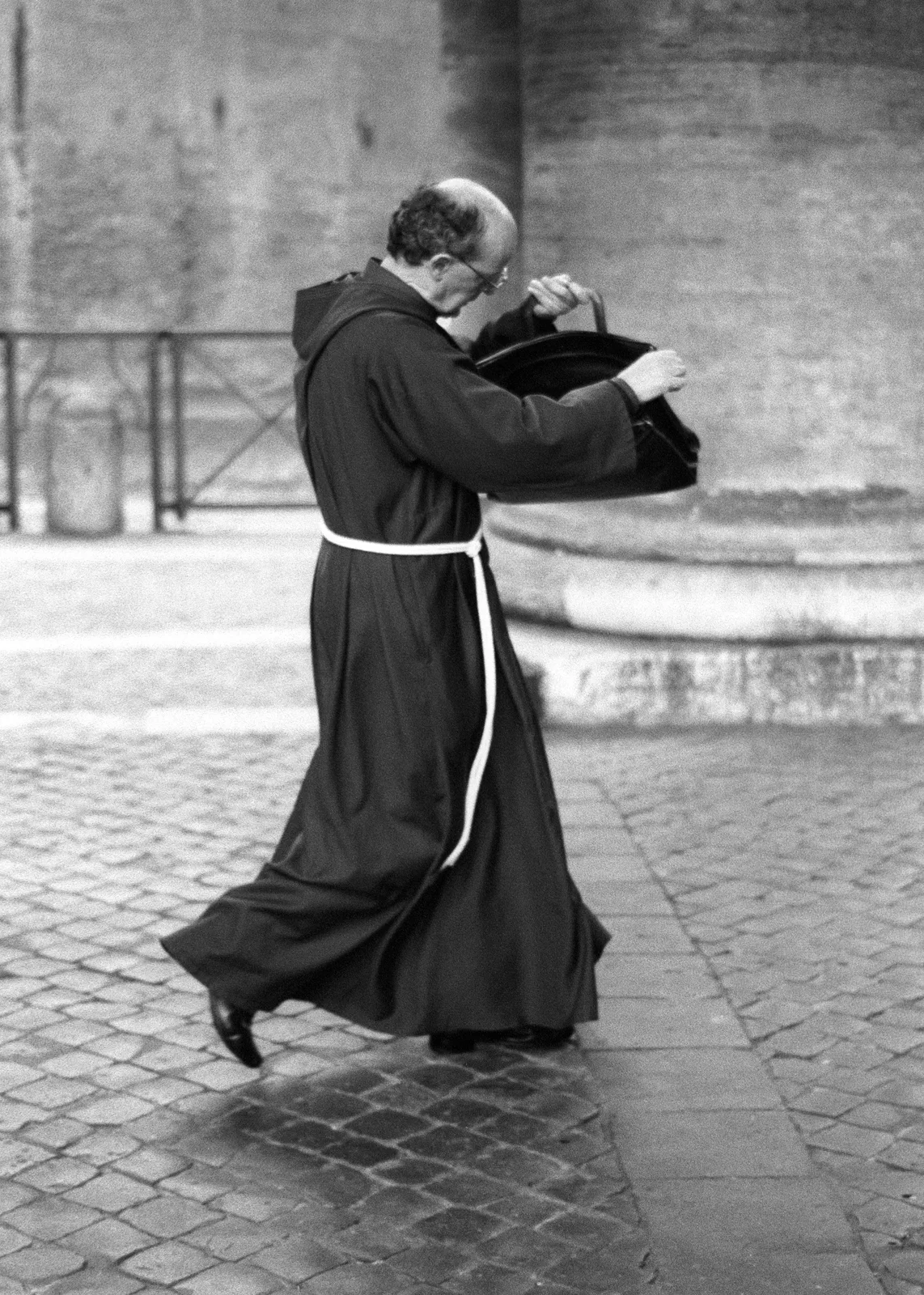 Priest checking his possessions on Piazza San Pietro